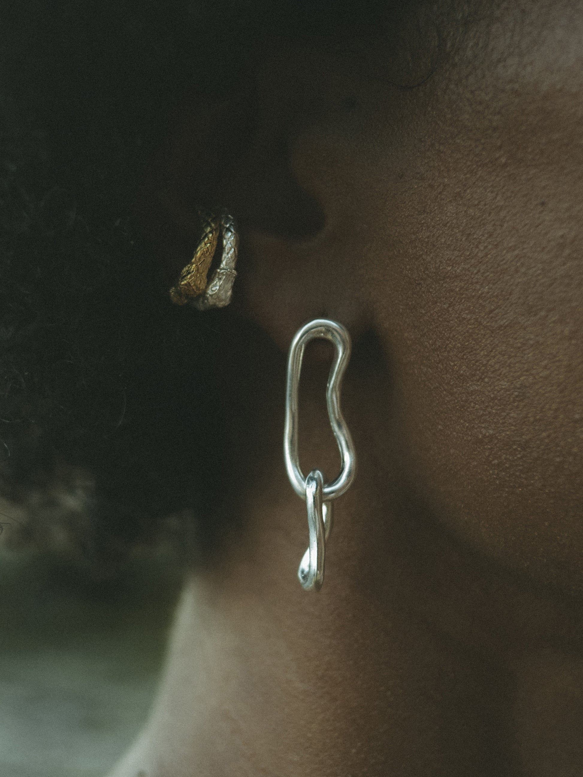 Eternity Drop Hoop Earrings. These elongated double-link earrings, crafted from a hand-forged chain by Pola, boast an organic shape that adds depth and sophistication to any look. Sterling Silver