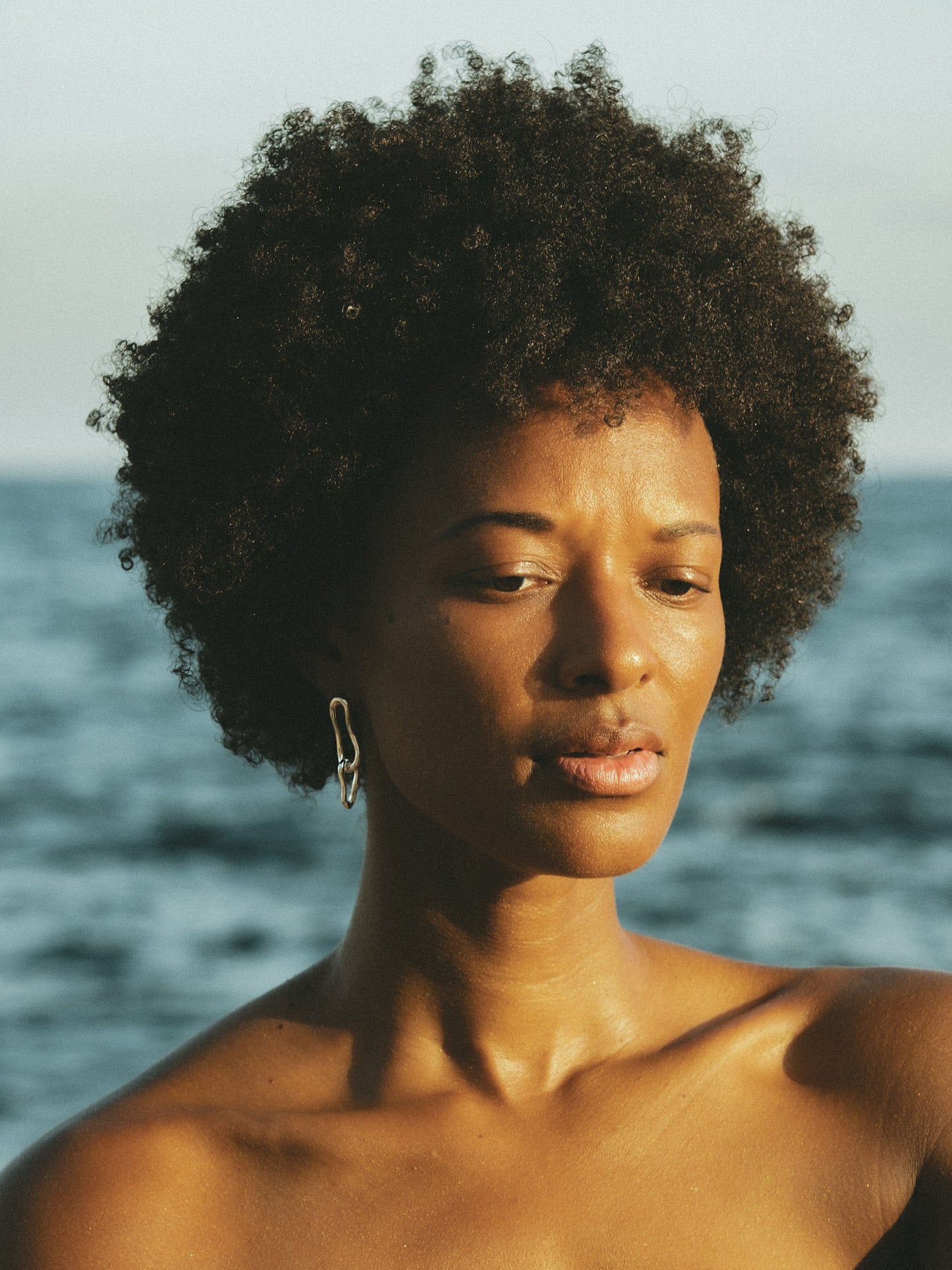 Eternity Drop Hoop Earrings. These elongated double-link earrings, crafted from a hand-forged chain by Pola, boast an organic shape that adds depth and sophistication to any look. Sterling Silver